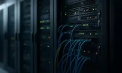 Serverracks mit Netzwerkgeräten und blauen Kabeln in einem Rechenzentrum.