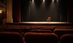 Leerer Theaterraum mit Bühne und gedimmtem Licht, symbolisch für das Lebenswerk des Schauspielers Uwe Kockisch