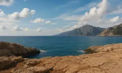 Felsige Mittelmeerküste mit ruhiger See und hellem Himmel, aufgenommen als neutrales Symbolbild ohne Menschen oder Gebäude.