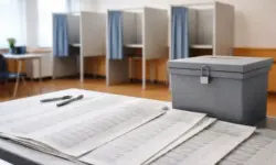 Wahlurne, Wahlkabinen und große Stimmzettel bei der Kommunalwahl Hessen 2026 in einem Wahllokal